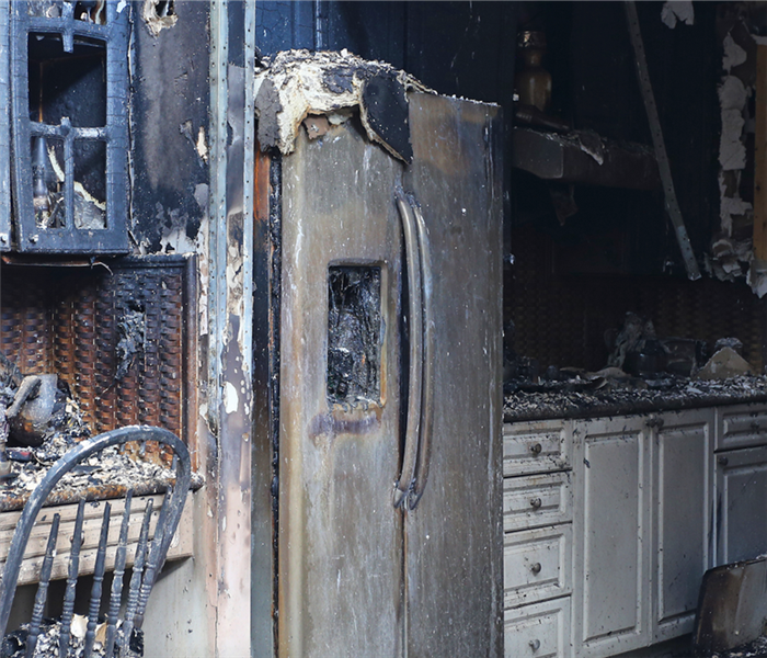 kitchen after a fire with cabinets and appliances burned